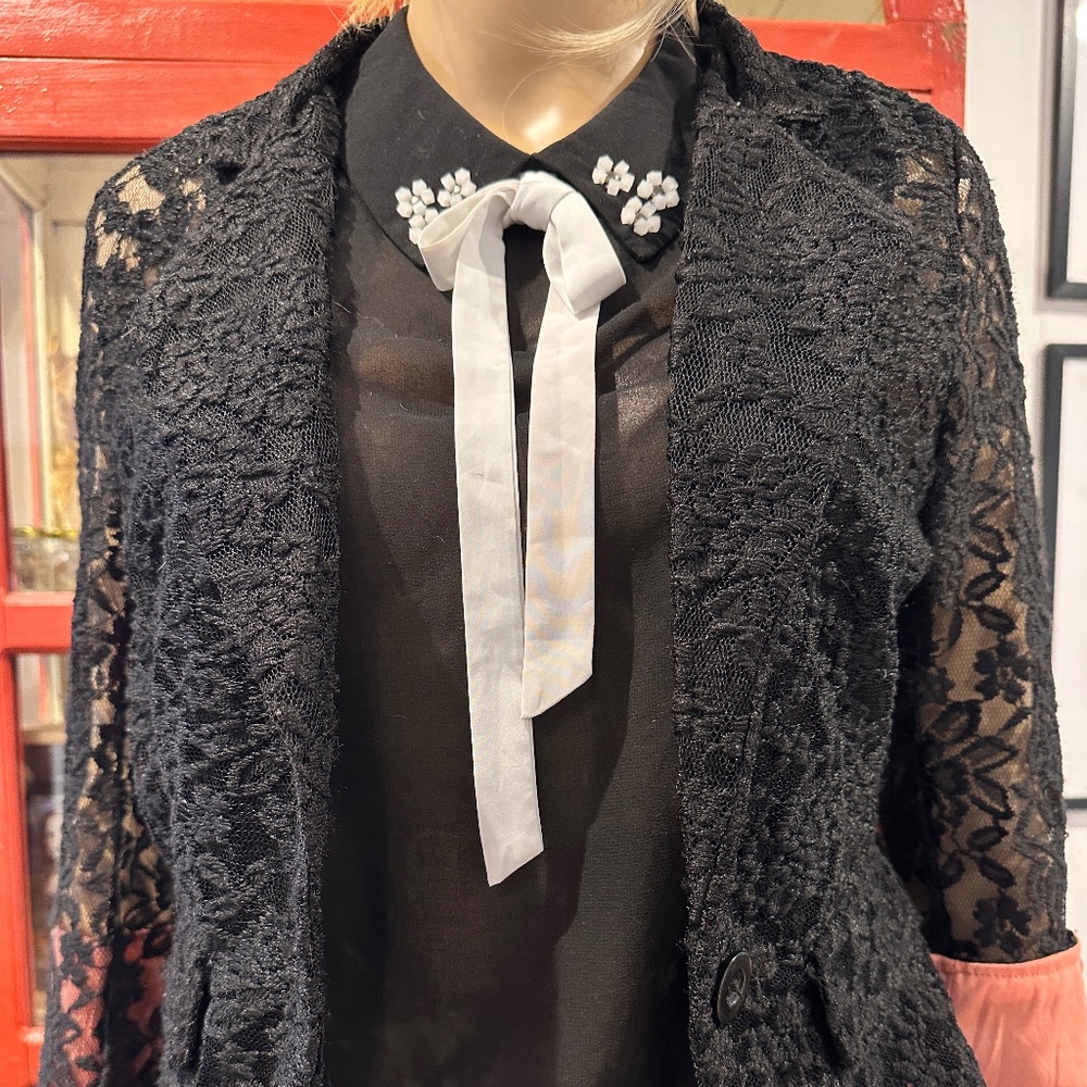 Black lace shrug with coral detail at cuffs and back seam Sz L